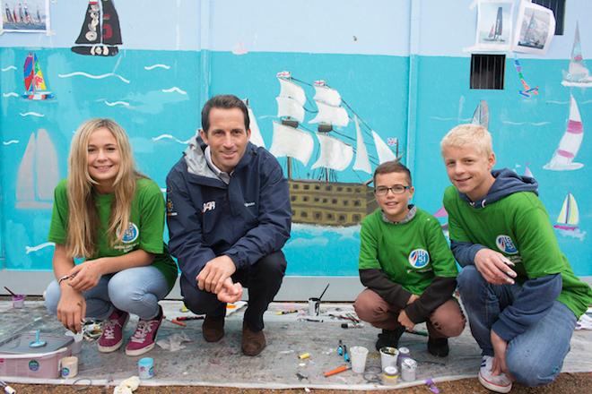 UK. Admiral Lord Nelson School pupils and Sir Ben Ainslie pictured painting HMS Victory on the walls of the new Ben Ainslie Racing HQ today.<br />
 © Lloyd Images